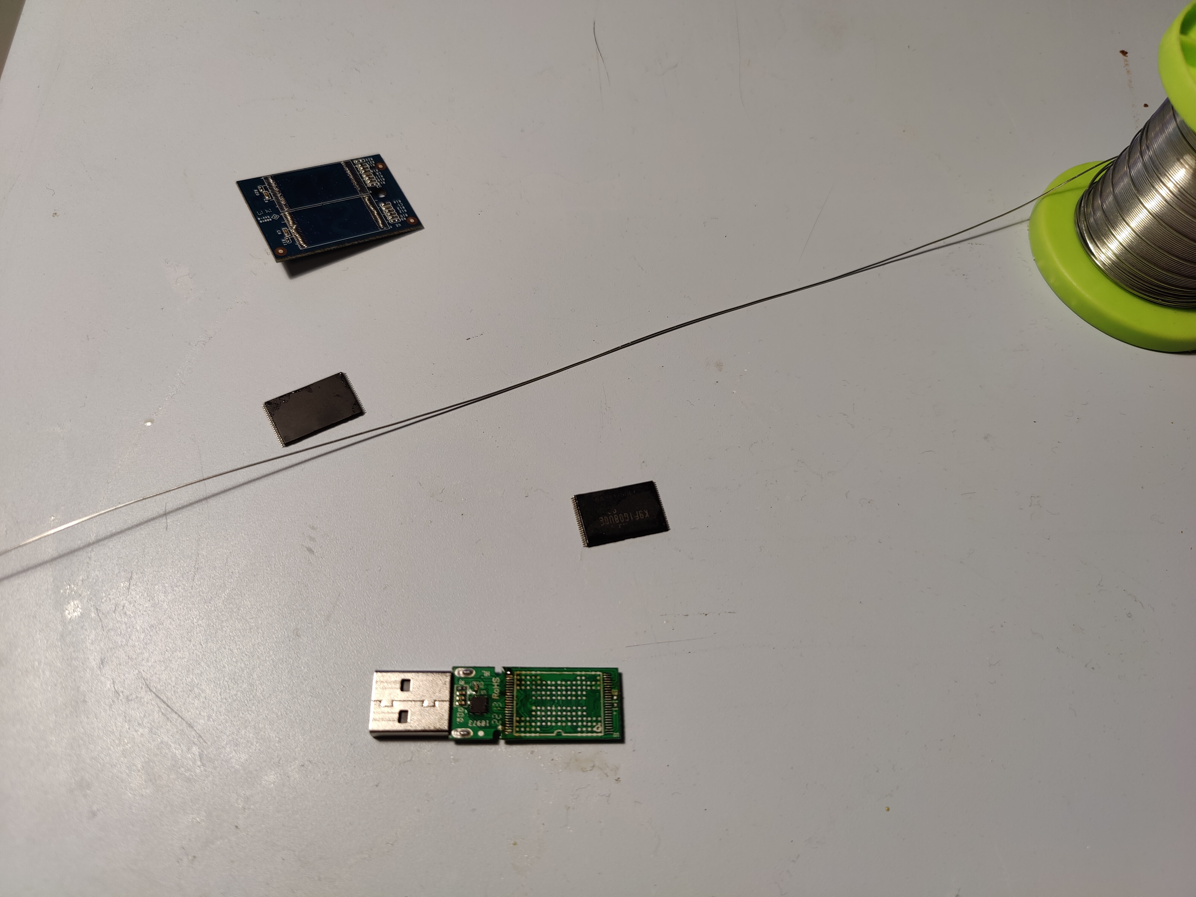 Picture of flash chips next to a USB drive and the flash daughterboard